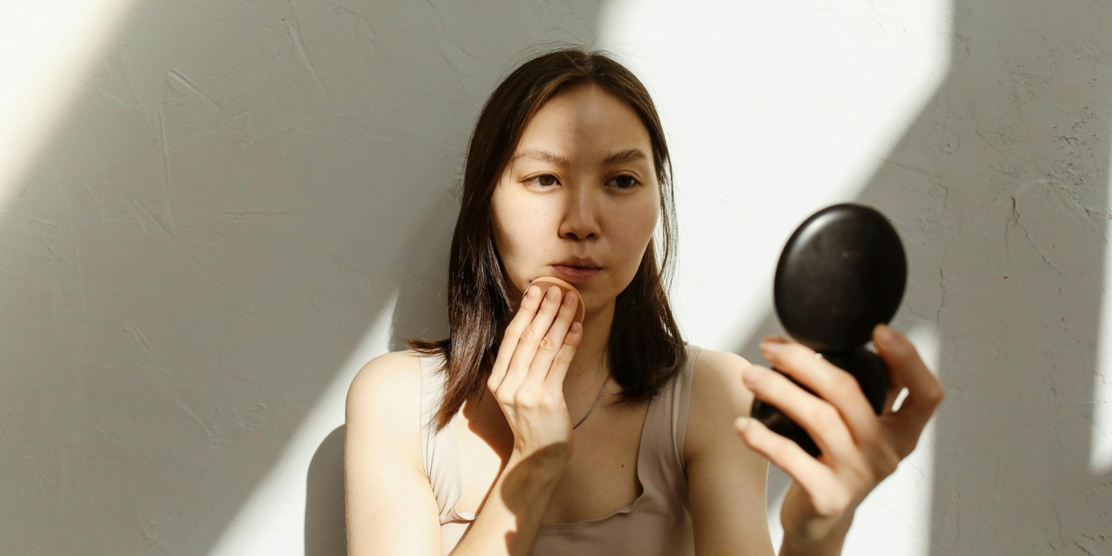 Woman examining her skin